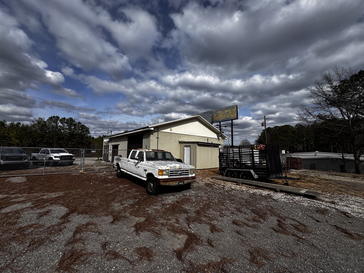 Front building, billboard and yard area.