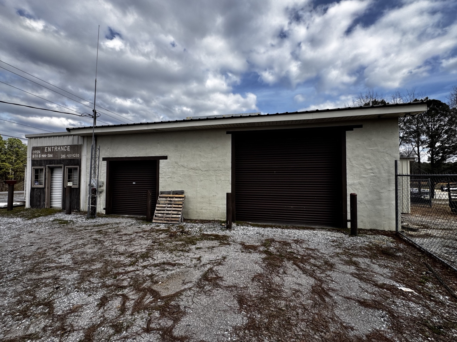 Front building with multiple roll-up doors.
